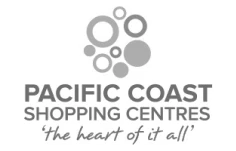 Logo for Pacific Coast Shopping Centres featuring various sizes of gray circles arranged in a cluster above the text. Below, the slogan "the heart of it all" is written in a cursive font. The overall color scheme is gray-scale.